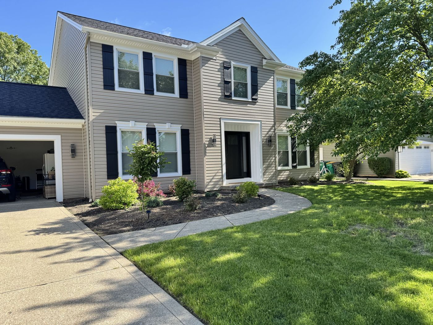Completed beige exterior with roofline and gutters