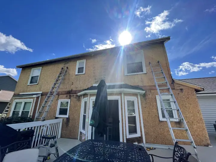 Beige siding transformation, in progress exterior view