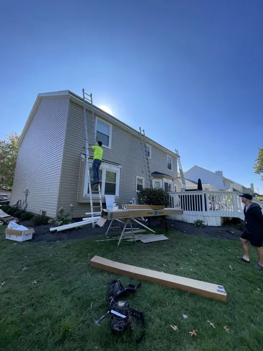 Beige siding transformation, in progress exterior view