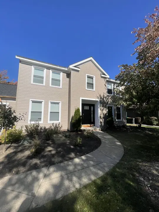 Beige siding transformation, finished exterior view