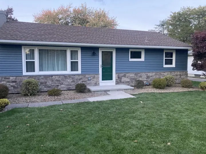 Completed blue siding and stone exterior