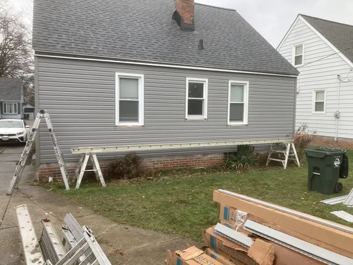 Gray siding installation in progress